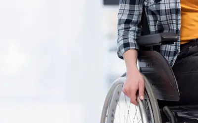 Osoba na wózku inwalidzkim zastanawia się, ile wynosi renta socjalna.