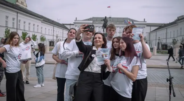 Młodzi ludzie z ulotkami "Młodzi Głosują" robią sobie selfie pod Pałacem Prezydenckim. Czy to odpowiedź na pytanie, dlaczego młodzi ludzie rzadko głosują na PiS?