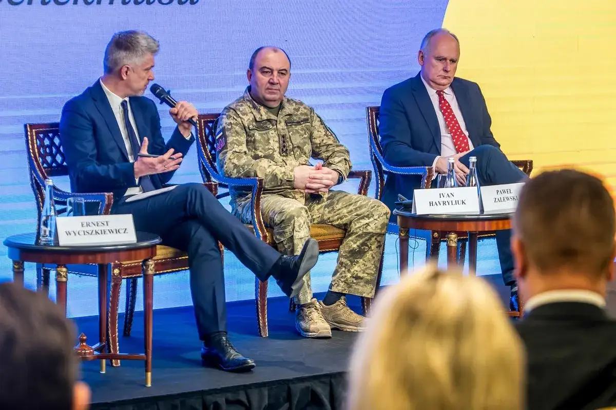 Dyskusja o pomocy militarnej dla Ukrainy i polityce obronnej kraju. Na scenie siedzą Ernest Wyciszkiewicz, Ivan Havryliuk w mundurze i Paweł Zalewski.