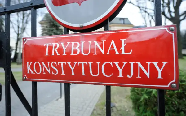 Tablica "Trybunał Konstytucyjny" na tle bramy. Symbol zmian w krs i trybunale konstytucyjnym za PIS.